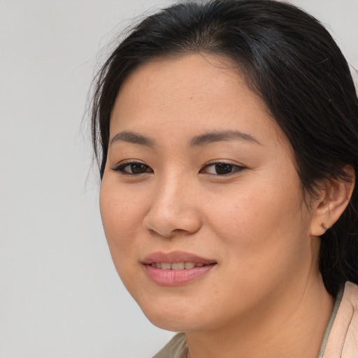 Joyful asian young-adult female with medium  brown hair and brown eyes