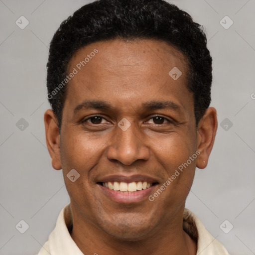 Joyful latino adult male with short  brown hair and brown eyes