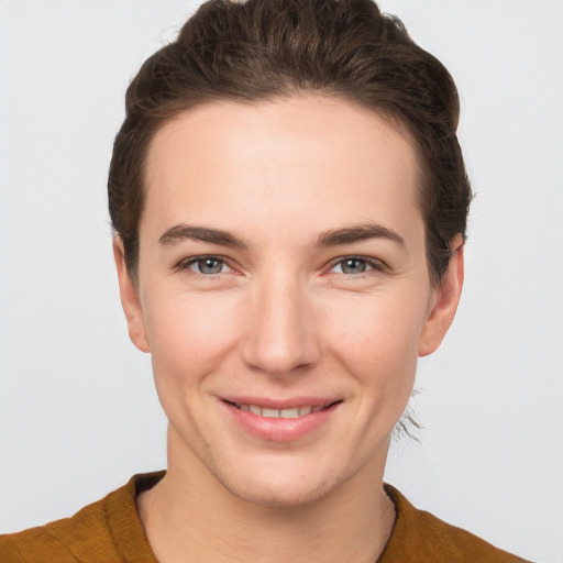 Joyful white young-adult female with short  brown hair and brown eyes