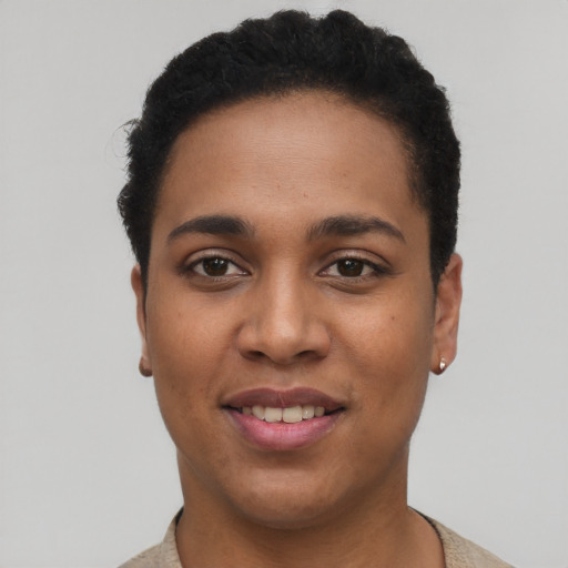 Joyful latino young-adult female with short  black hair and brown eyes