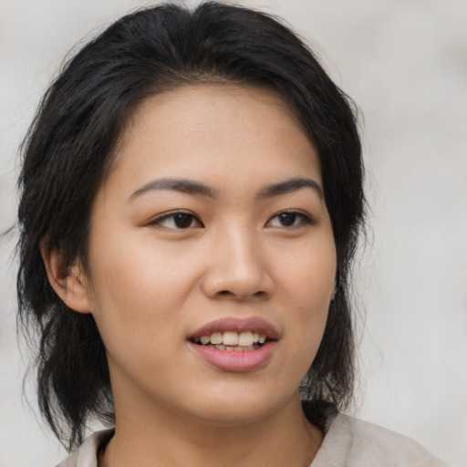 Joyful asian young-adult female with medium  black hair and brown eyes