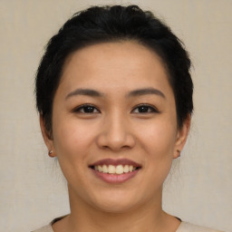 Joyful asian young-adult female with short  brown hair and brown eyes