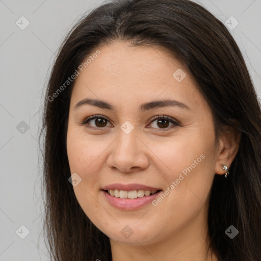 Joyful white young-adult female with long  brown hair and brown eyes