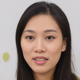 Joyful asian young-adult female with long  brown hair and brown eyes