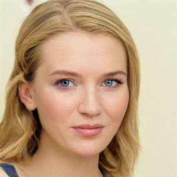 Joyful white young-adult female with long  brown hair and blue eyes