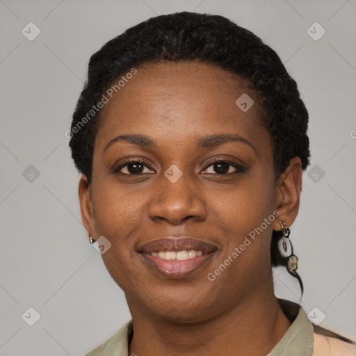 Joyful black young-adult female with short  black hair and brown eyes