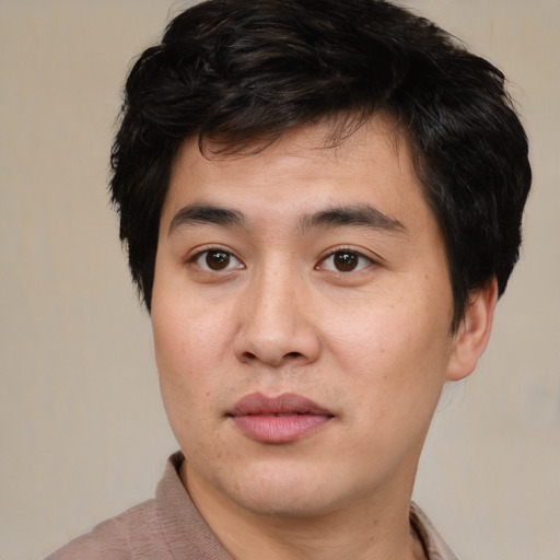 Joyful asian young-adult male with short  brown hair and brown eyes