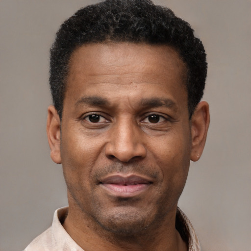 Joyful latino adult male with short  black hair and brown eyes