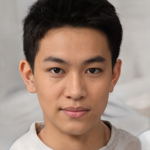 Joyful asian young-adult male with short  brown hair and brown eyes