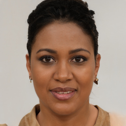 Joyful black young-adult female with short  brown hair and brown eyes