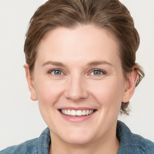 Joyful white young-adult female with medium  brown hair and blue eyes