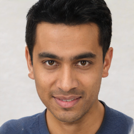 Joyful white young-adult male with short  black hair and brown eyes