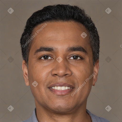 Joyful latino young-adult male with short  black hair and brown eyes