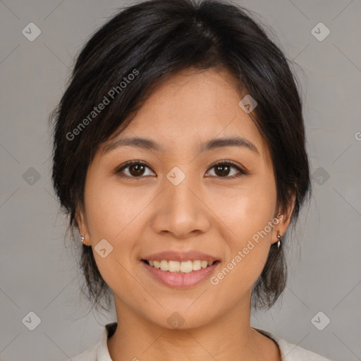 Joyful asian young-adult female with medium  brown hair and brown eyes