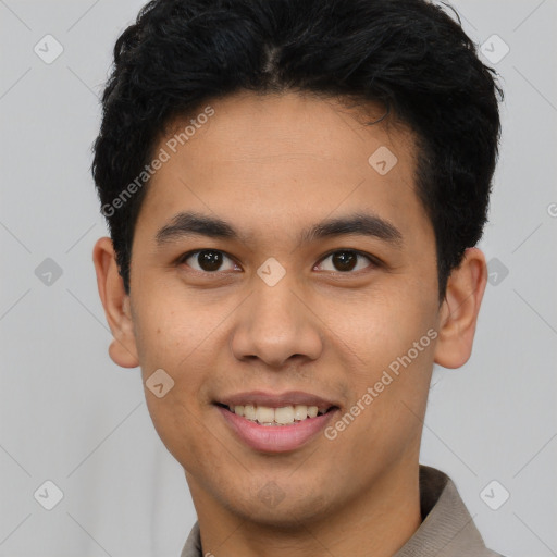 Joyful latino young-adult male with short  black hair and brown eyes