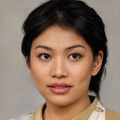 Joyful asian young-adult female with medium  brown hair and brown eyes