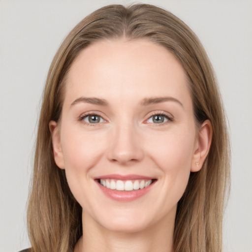 Joyful white young-adult female with long  brown hair and grey eyes