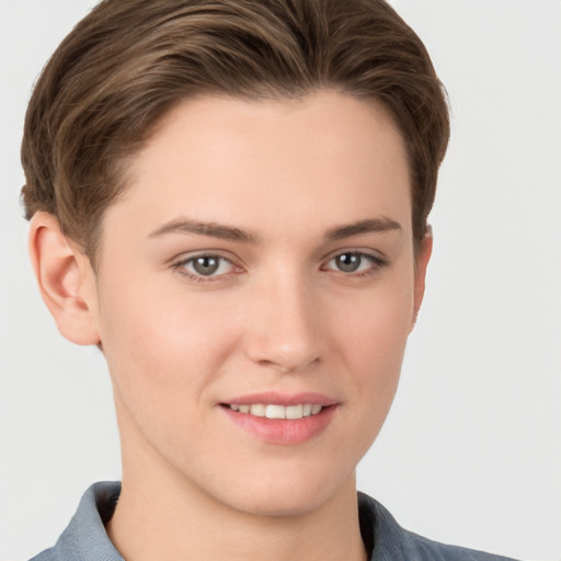 Joyful white young-adult female with short  brown hair and grey eyes