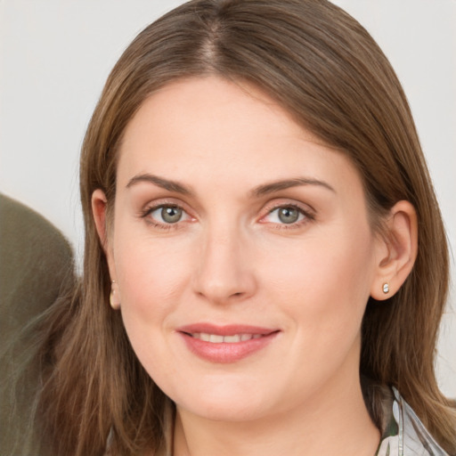 Joyful white young-adult female with long  brown hair and grey eyes