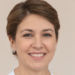 Joyful white adult female with short  brown hair and brown eyes