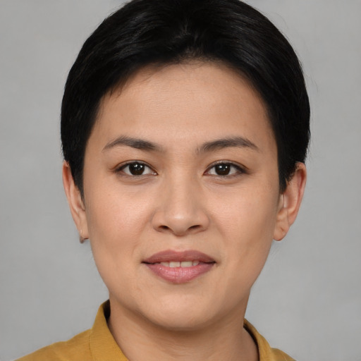 Joyful asian young-adult female with short  brown hair and brown eyes