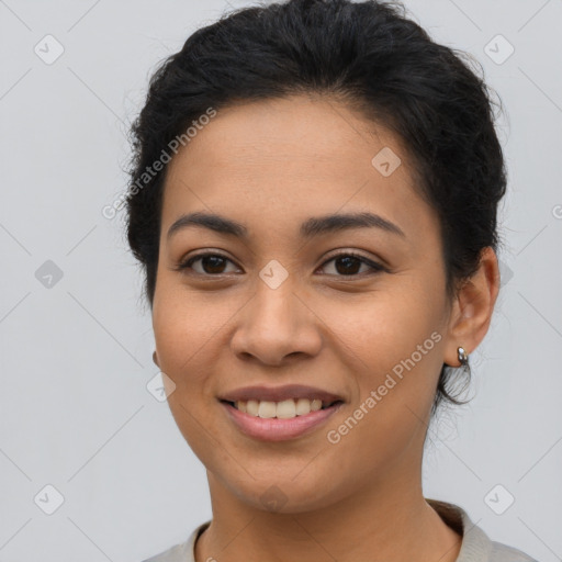 Joyful latino young-adult female with short  brown hair and brown eyes