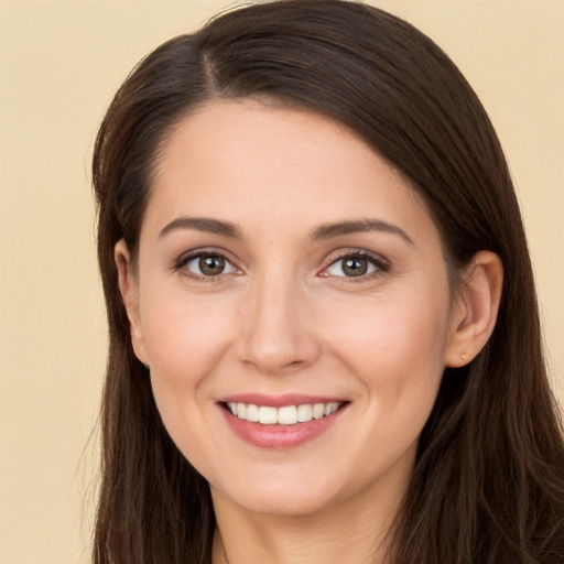 Joyful white young-adult female with long  brown hair and brown eyes