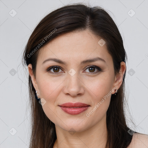 Joyful white young-adult female with long  brown hair and brown eyes