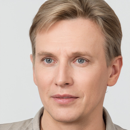 Joyful white adult male with short  brown hair and grey eyes