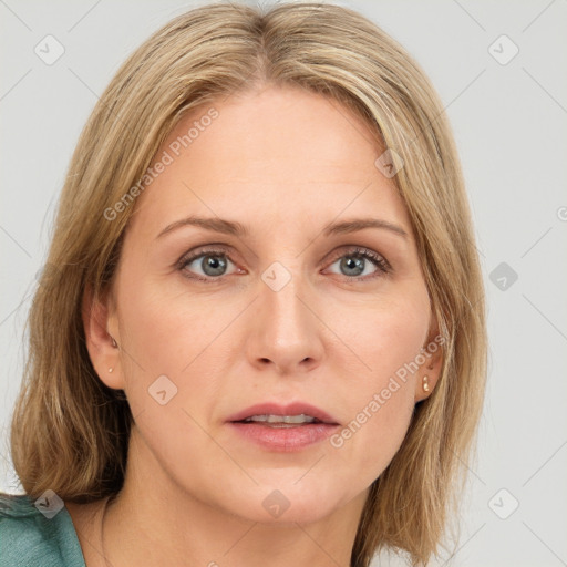 Joyful white adult female with medium  brown hair and blue eyes