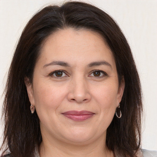 Joyful white adult female with medium  brown hair and brown eyes