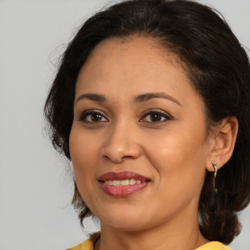 Joyful white adult female with medium  brown hair and brown eyes