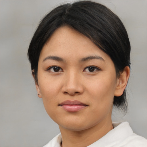 Joyful asian young-adult female with medium  brown hair and brown eyes