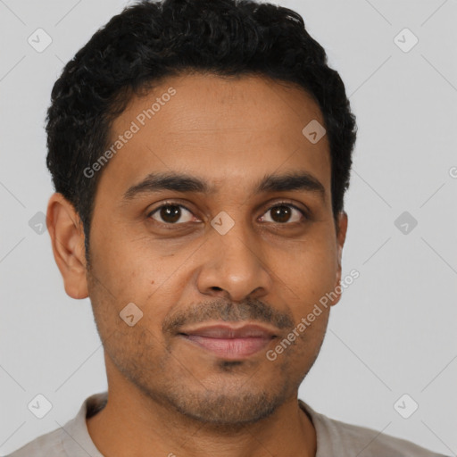 Joyful latino young-adult male with short  black hair and brown eyes