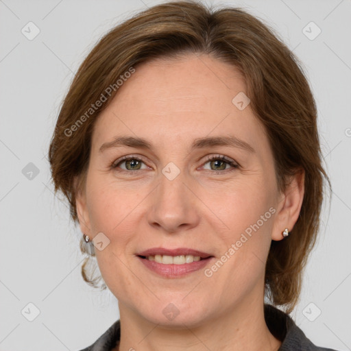 Joyful white adult female with medium  brown hair and grey eyes