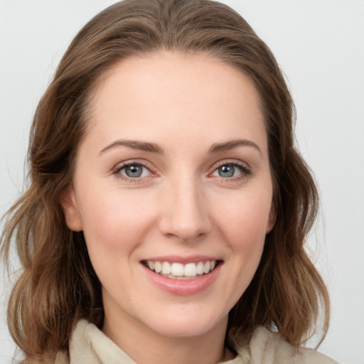 Joyful white young-adult female with medium  brown hair and blue eyes