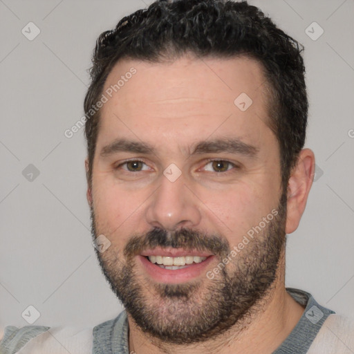 Joyful white young-adult male with short  black hair and brown eyes