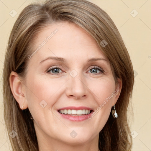 Joyful white adult female with long  brown hair and grey eyes