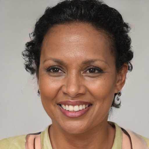 Joyful black adult female with short  brown hair and brown eyes
