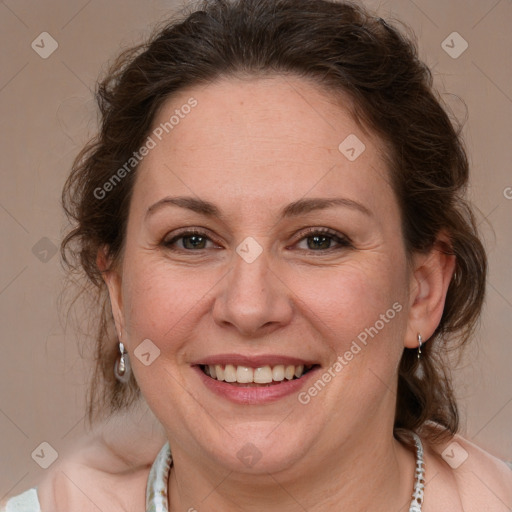 Joyful white adult female with medium  brown hair and blue eyes