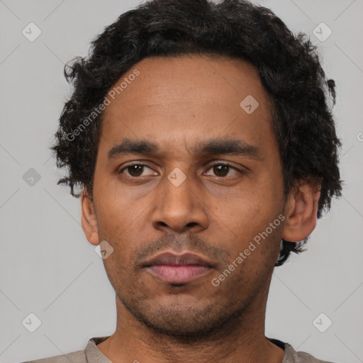 Neutral latino adult male with short  black hair and brown eyes