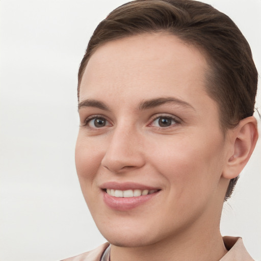 Joyful white young-adult female with short  brown hair and brown eyes