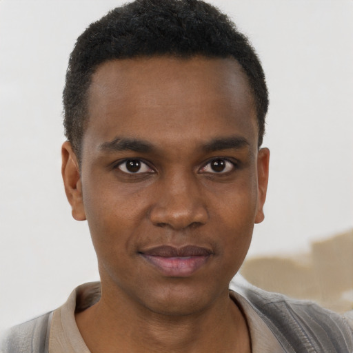 Joyful black young-adult male with short  brown hair and brown eyes