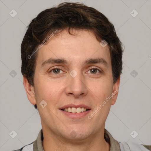 Joyful white adult male with short  brown hair and grey eyes