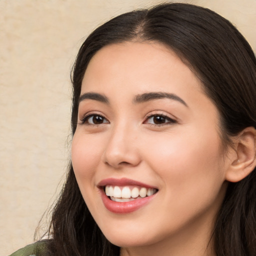 Joyful white young-adult female with long  brown hair and brown eyes