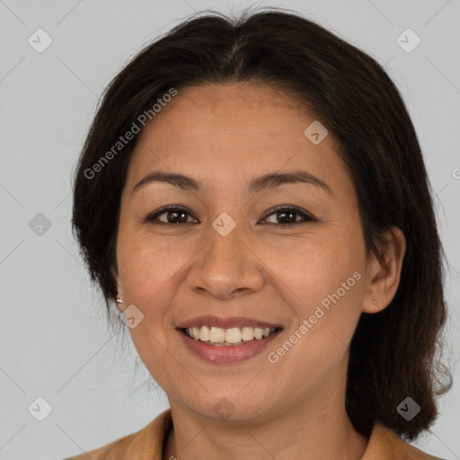 Joyful asian adult female with medium  brown hair and brown eyes