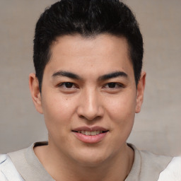 Joyful latino young-adult male with short  brown hair and brown eyes