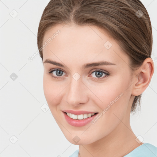 Joyful white young-adult female with medium  brown hair and grey eyes