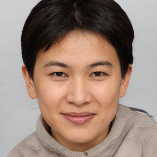 Joyful asian young-adult female with short  brown hair and brown eyes