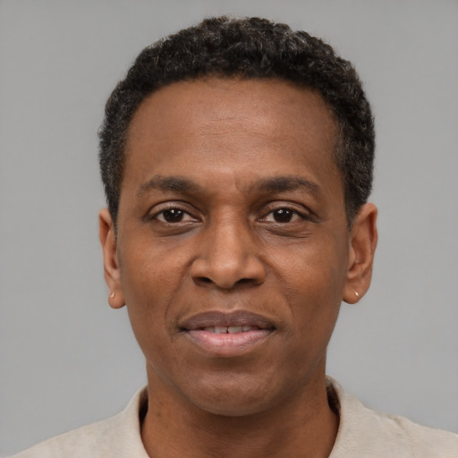 Joyful black adult male with short  black hair and brown eyes